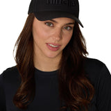 Female model styling the Till I Die black Puffer Hat with puff embroidered front logo and snapback closure