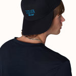 Male model wearing Ride Till I Die hat backwards with logo visible