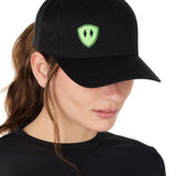 Front view of a female wearing a black classic trucker hat with a lime embroidered double diamond shield on the bottom right panel