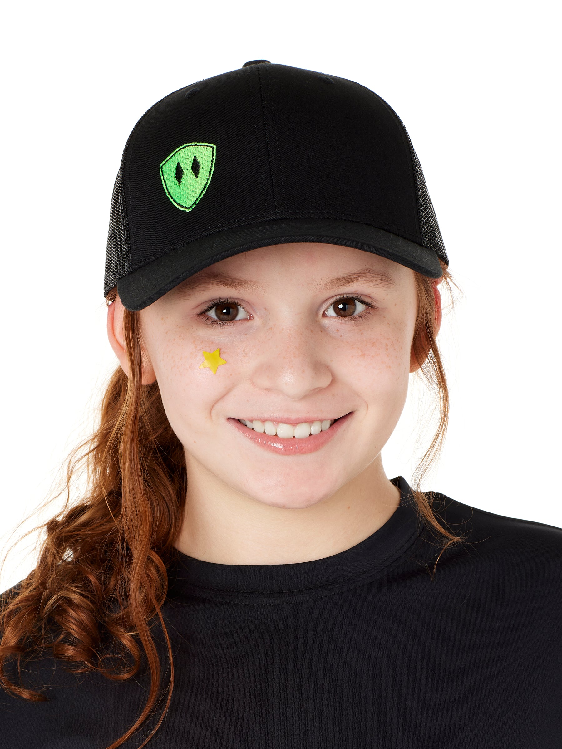 Front view of a youth wearing a black classic trucker hat with a lime embroidered double diamond shield on the bottom right panel