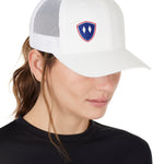 Front view of a female wearing a white classic trucker hat with a blue and red embroidered double diamond shield on the bottom right panel