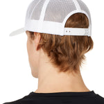 back view of a male model wearing a white classic trucker hat showing the mesh back panels and matching snapback closure