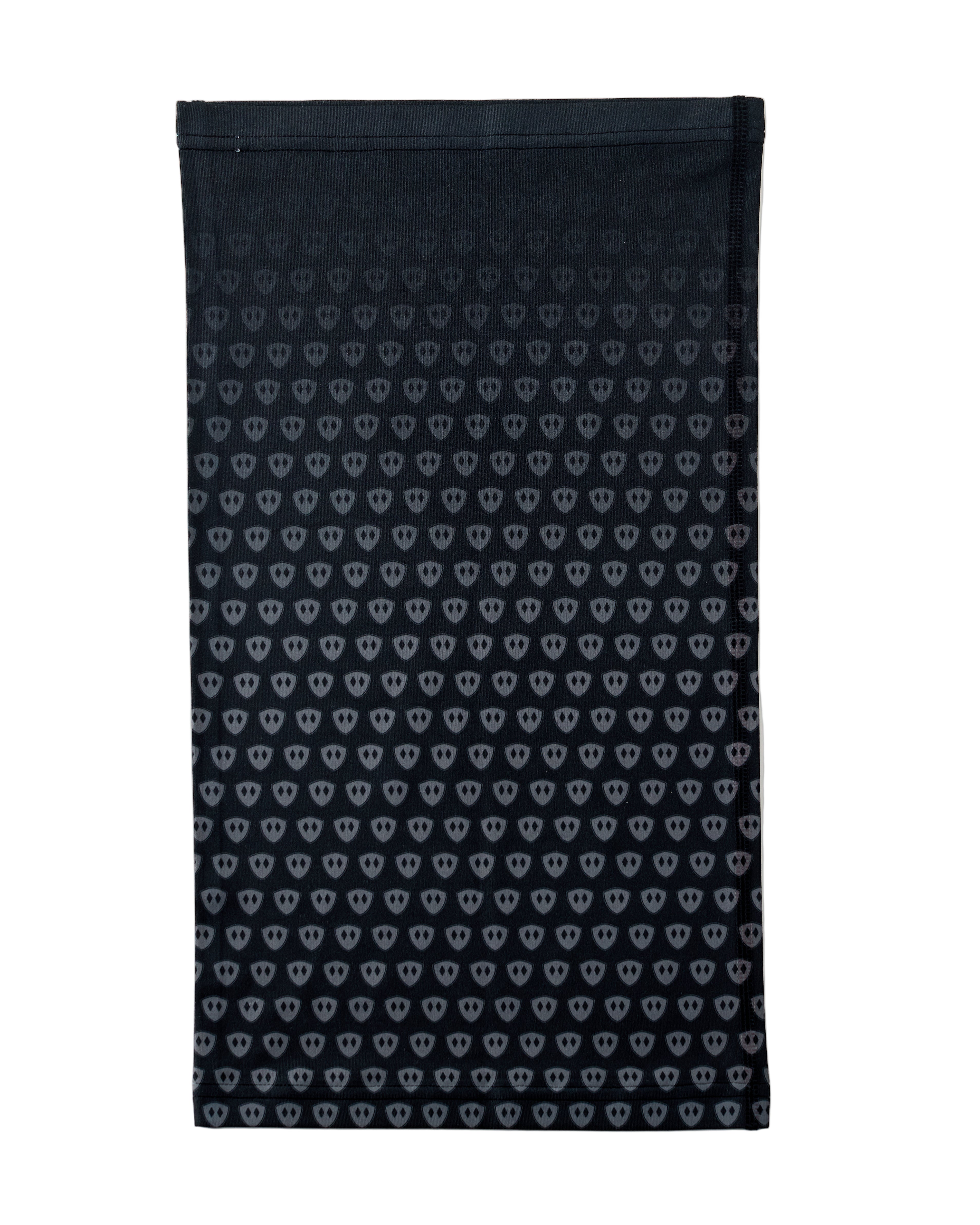 Overhead flat lay image of the back side of a black neck gaiter featuring a repeating dark gray diamond-shield pattern. The gaiter is placed on a white background.