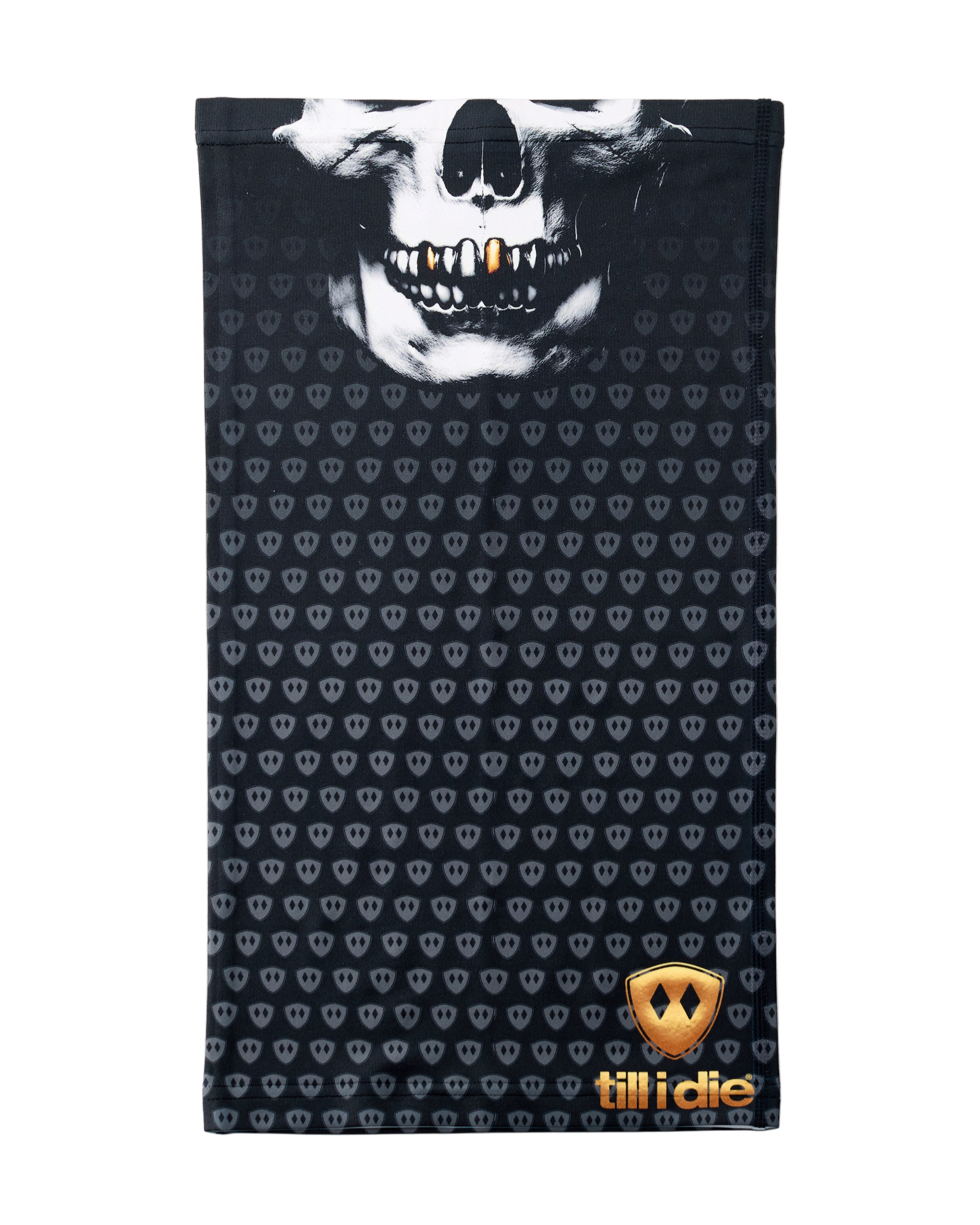 Overhead flat lay image of a black neck gaiter featuring a repeating dark gray diamond-shield pattern. The top portion shows a white skull graphic with gold teeth, and the bottom right corner displays a gold Till I Die logo. The gaiter is laid flat on a white background.