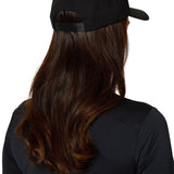 Back view of female model wearing Ski Till I Die black snapback hat with long hair and athletic top