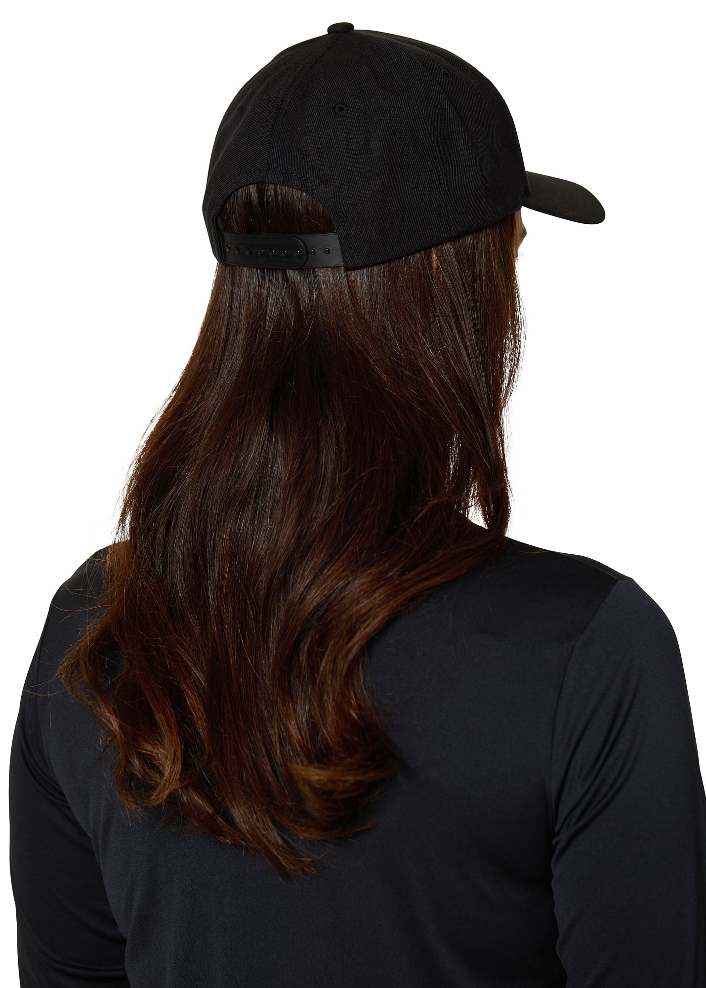 Back view of female model wearing Ski Till I Die black snapback hat with long hair and athletic top