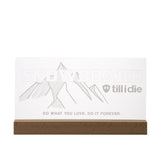 Clear acrylic LED sign with ÒSnowboard Till I DieÓ mountain graphic and etched lettering, mounted on a wood base, with multicolor light-up feature.