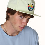 male model wearing a lime surf hat and stone was denim tee shirt