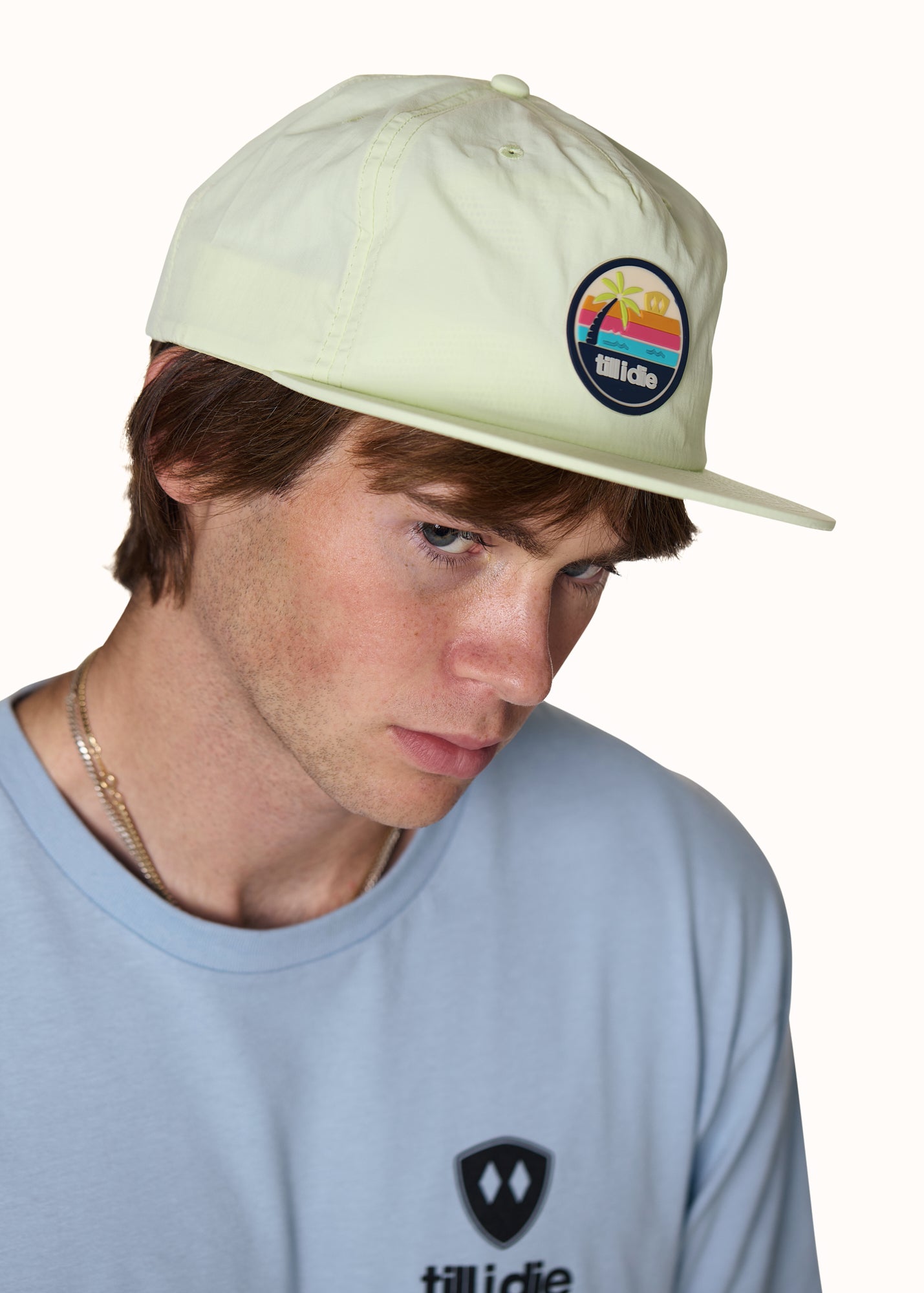 male model wearing a lime surf hat and stone was denim tee shirt
