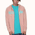 male model wearing a rose pink zip hoodie with "till i die" across the front, teal T shirt, and black surf cap on a white background