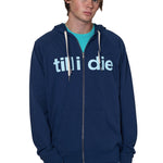 Model wearing a indigo blue zip up hoodie with Till I Die logo, Marigold Surf Cap, and Tahiti Blue shirt on a white background