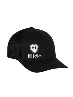 Front view of a black classic trucker hat, featuring a white embroidered Till I Die logo with double black diamonds and a white shield on the lower right front panel on a white background.