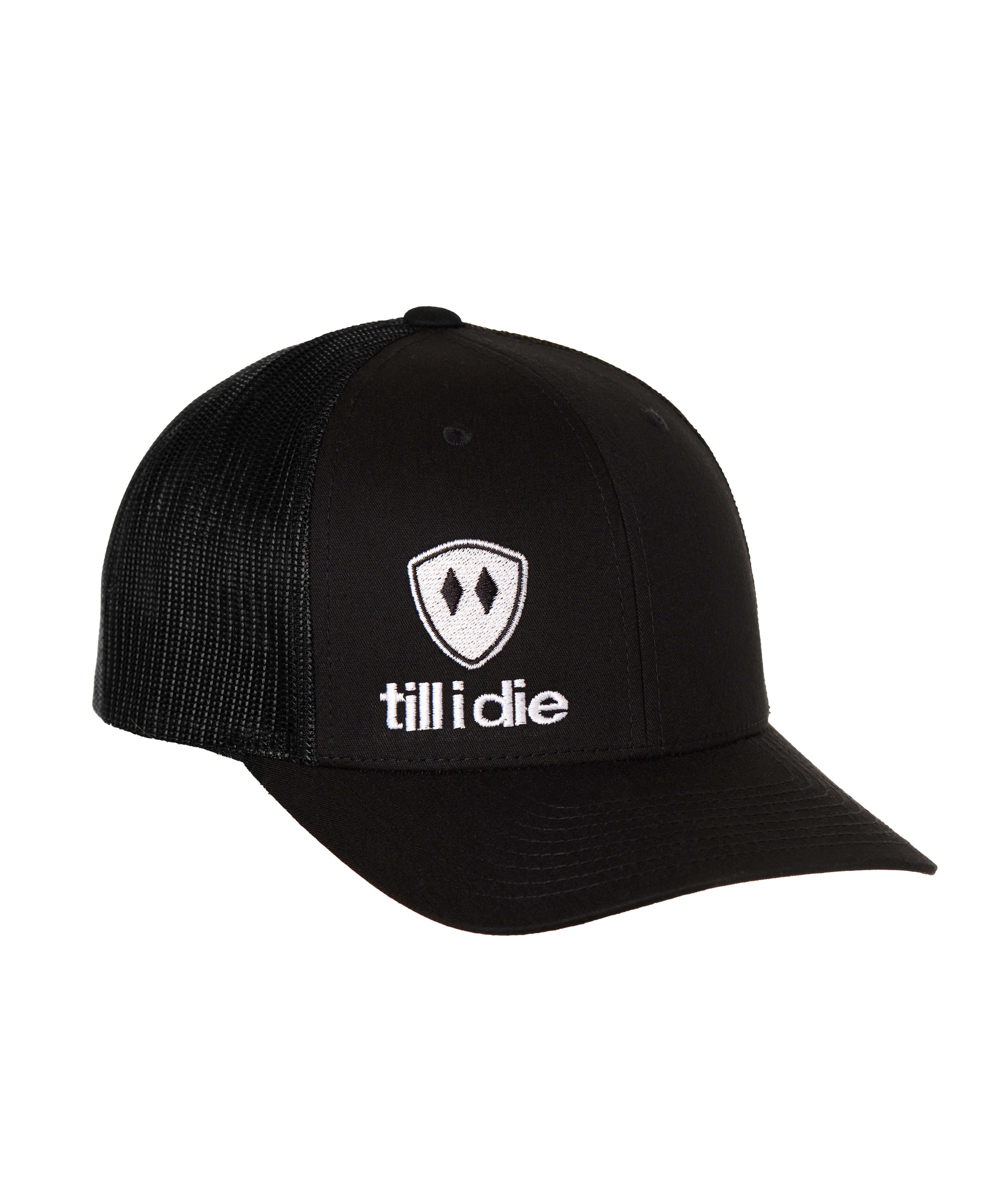 Front view of a black classic trucker hat, featuring a white embroidered Till I Die logo with double black diamonds and a white shield on the lower right front panel on a white background.