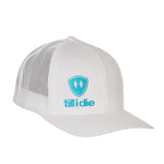 Front view of a white classic trucker hat, featuring a teal embroidered Till I Die logo with double white diamonds and a teal shield on the lower right front panel on a white background.