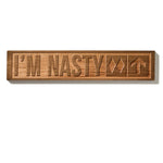 The “I’m Nasty” ski trail sign shown on a white background, featuring natural cherry wood with visible grain. The design includes double black diamonds and an upward-pointing arrow.