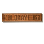 The “I’m Okay” ski trail sign shown on a white background, featuring natural cherry wood with visible grain. The design includes a square and an upward-pointing arrow.