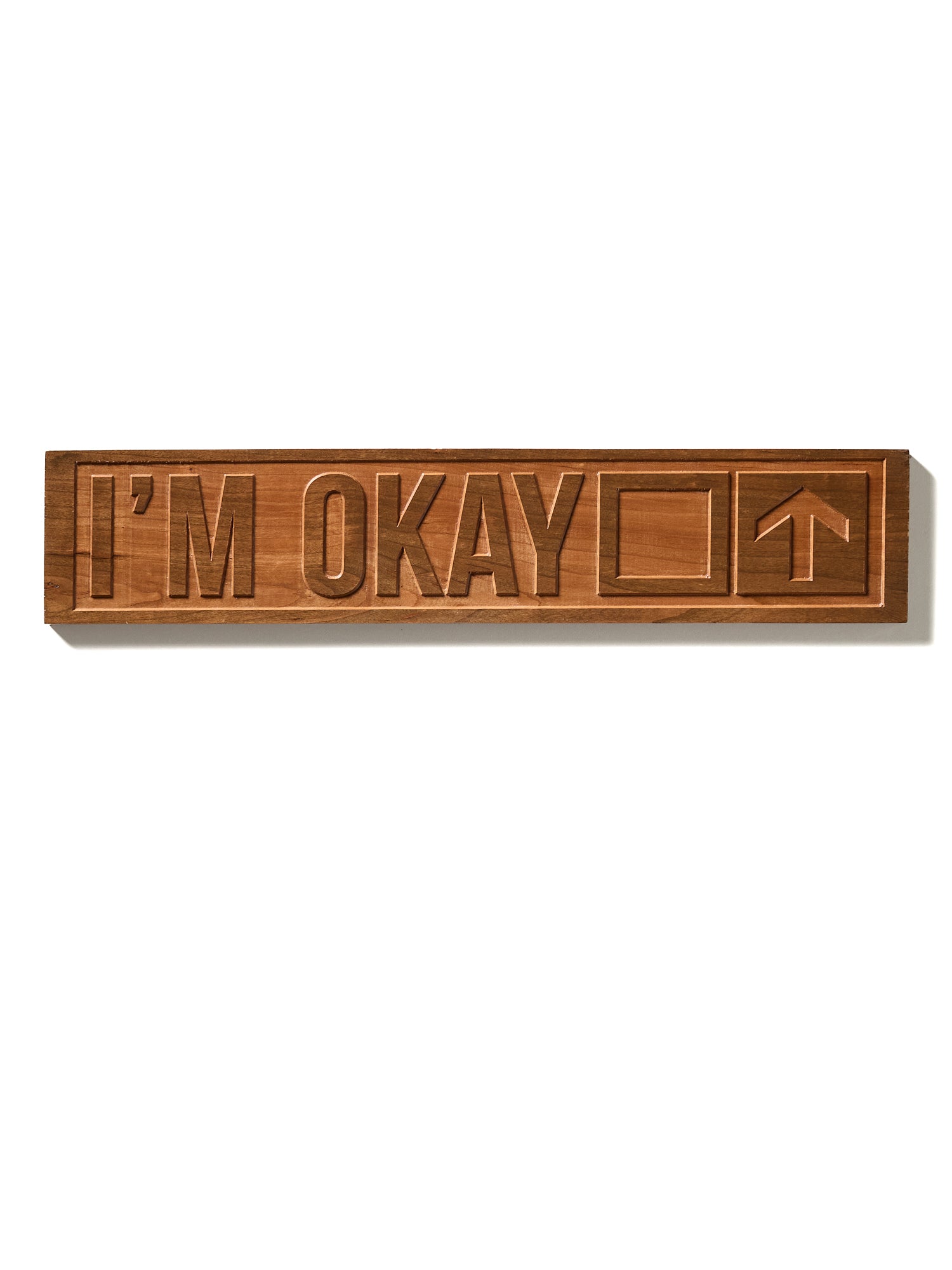 The “I’m Okay” ski trail sign shown on a white background, featuring natural cherry wood with visible grain. The design includes a square and an upward-pointing arrow.