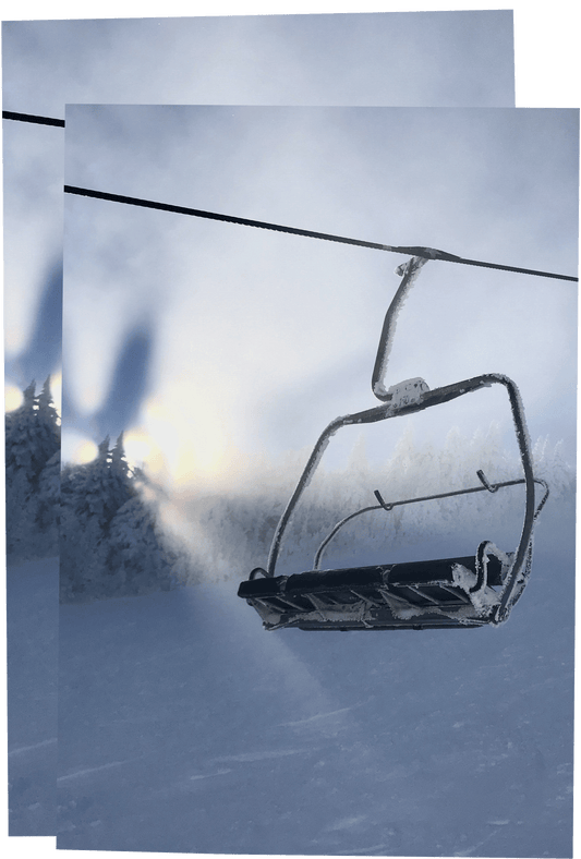 Ski lift in a snowy landscape with a sunlit sky